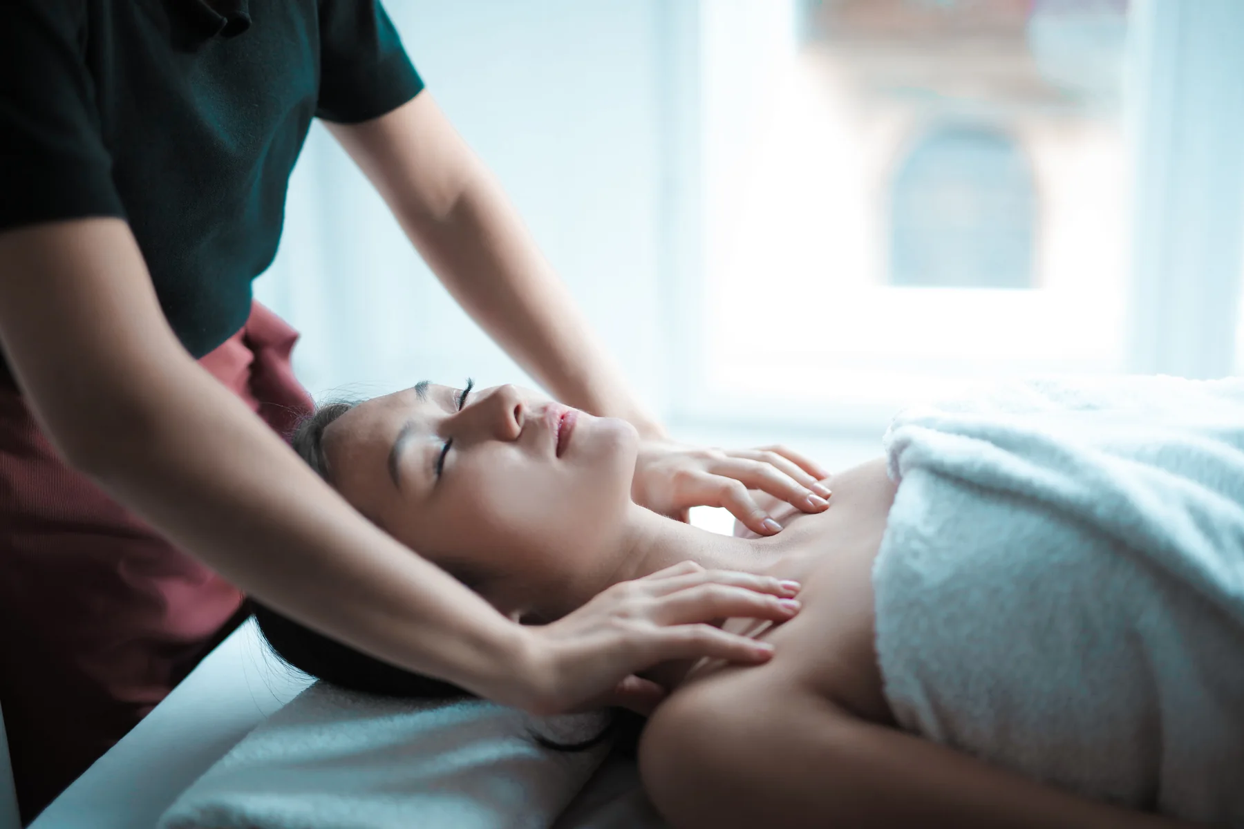 Professional neck and shoulder massage in a bright spa setting